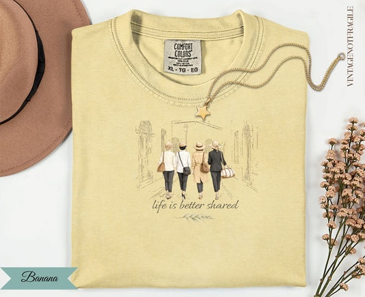Cream t-shirt with graphic of four women walking with the text "Life is better shared".