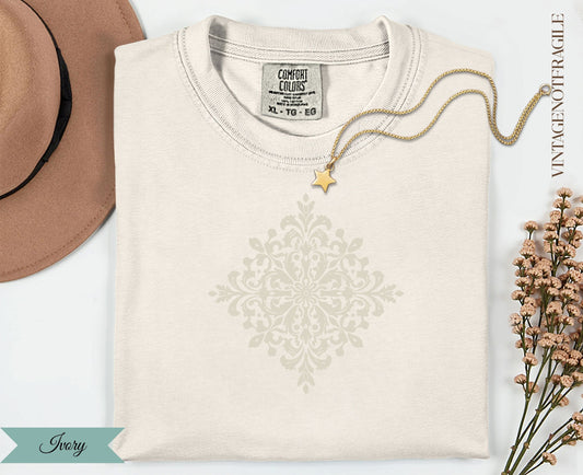 Ivory t-shirt with light gray ornate mandala graphic and "VINTAGENOTFRAGILE" text.