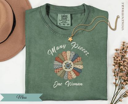 Green t-shirt with "Many Pieces. One Woman." floral applique.