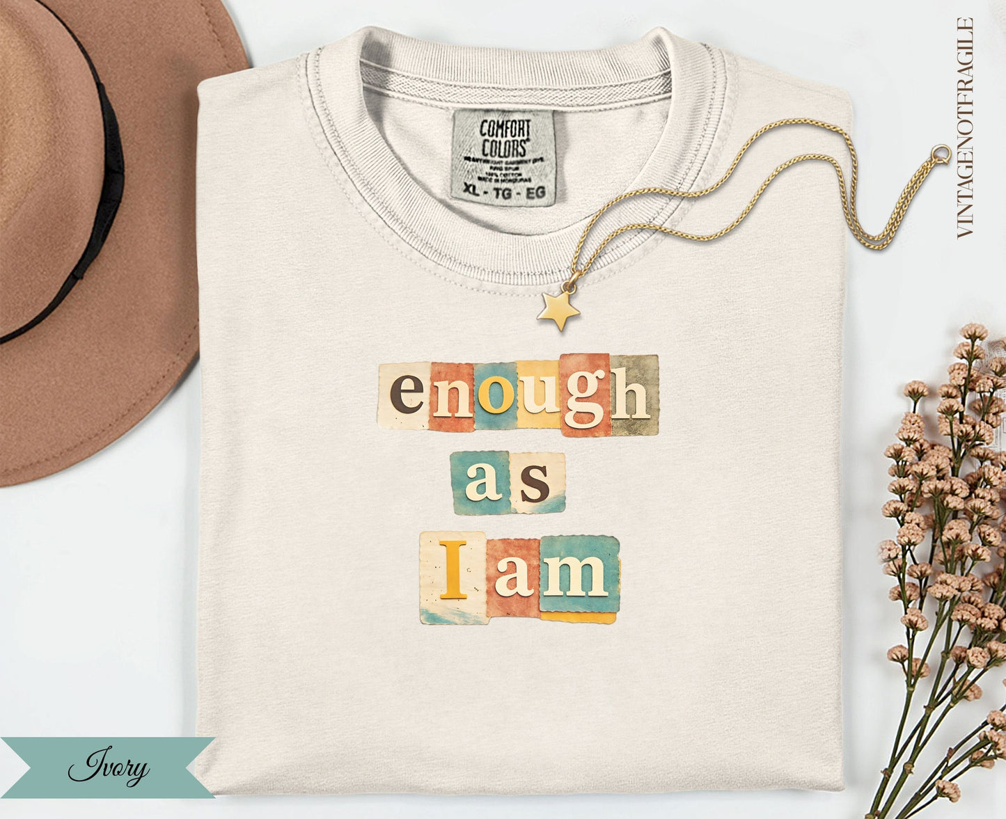 Cream t-shirt with "enough as i am" in block letters.