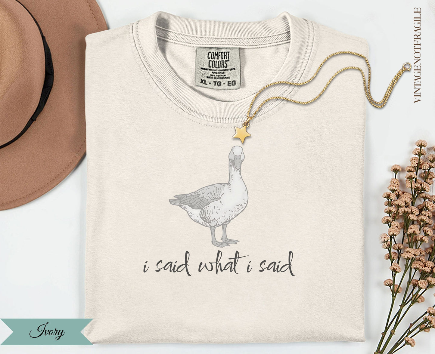 Cream t-shirt with goose graphic and "i said what i said" text.
