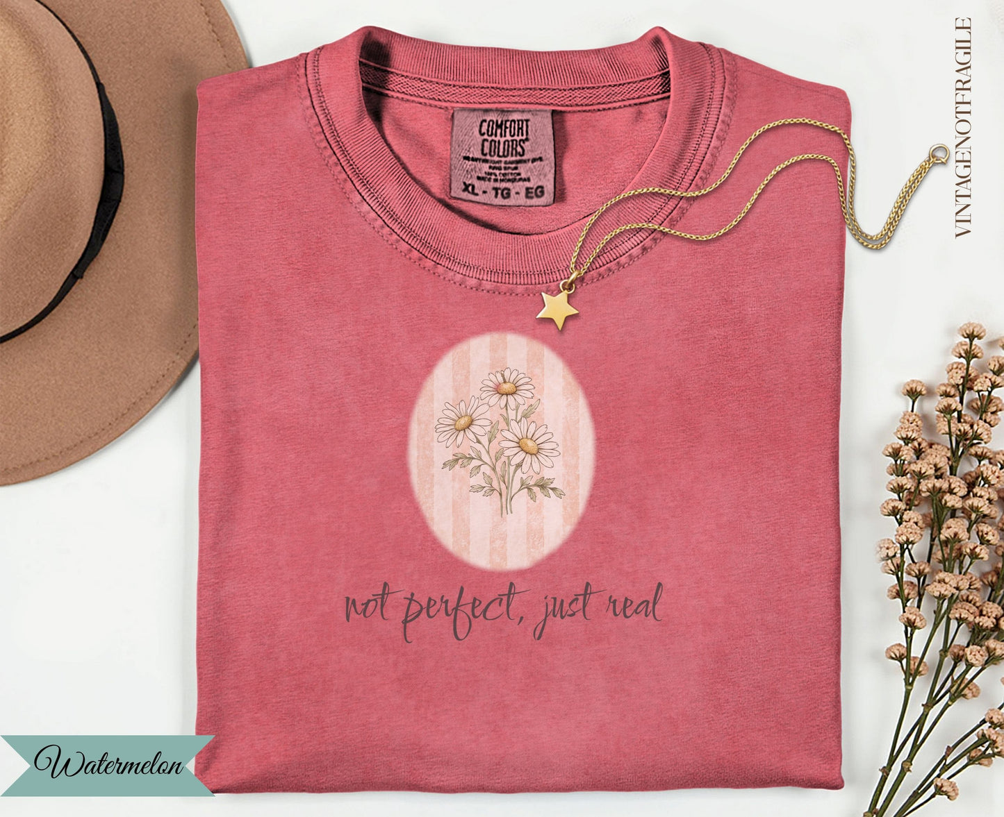 Coral t-shirt with floral graphic and text "not perfect, just real".