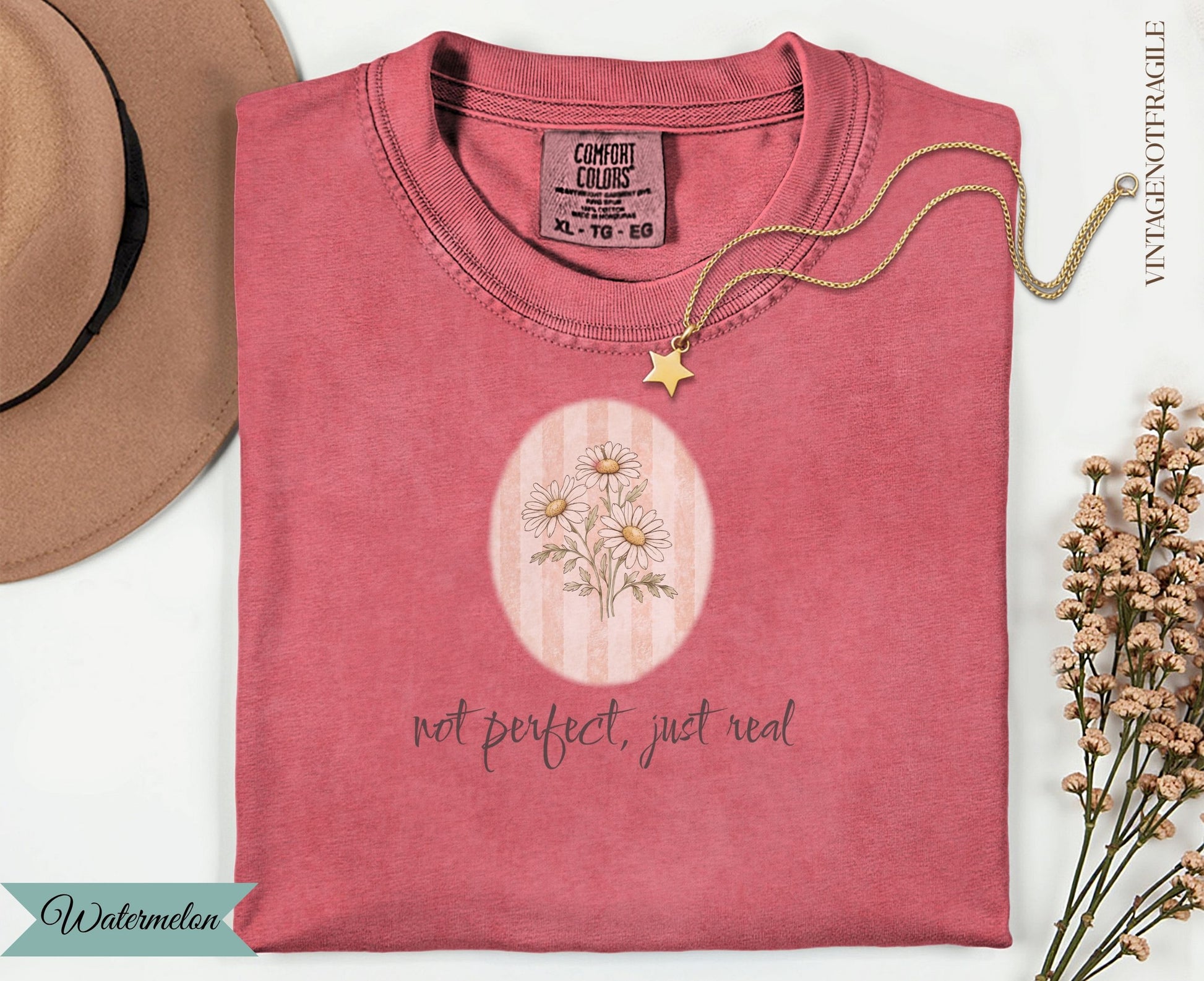 Coral t-shirt with floral graphic and text "not perfect, just real".