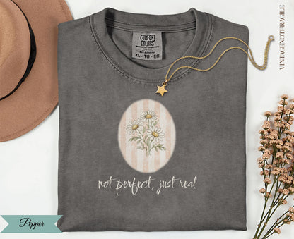 Comfort Colors t-shirt with floral daisy design and "not perfect, just real" text.
