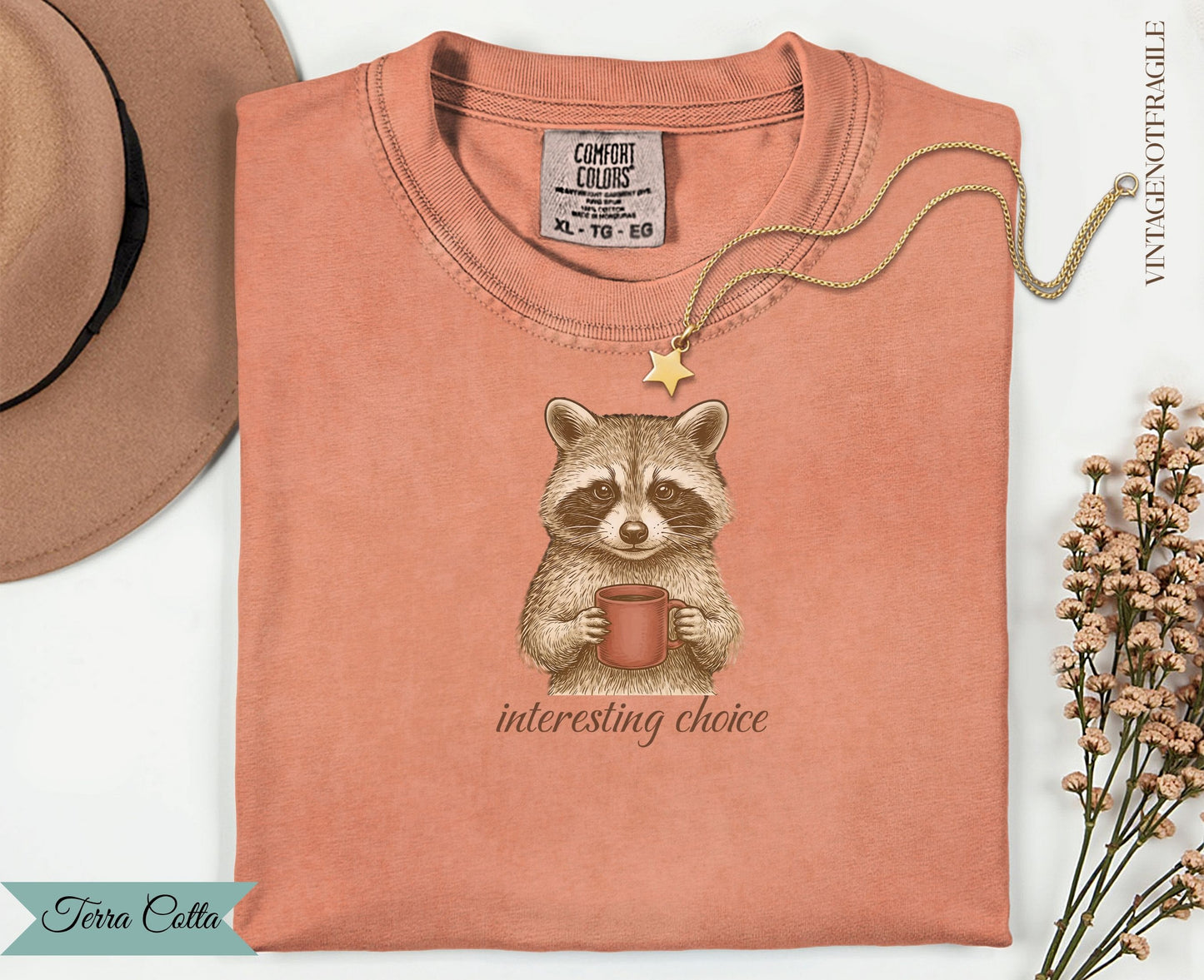 T-shirt with a raccoon holding a coffee mug and the text "interesting choice".
