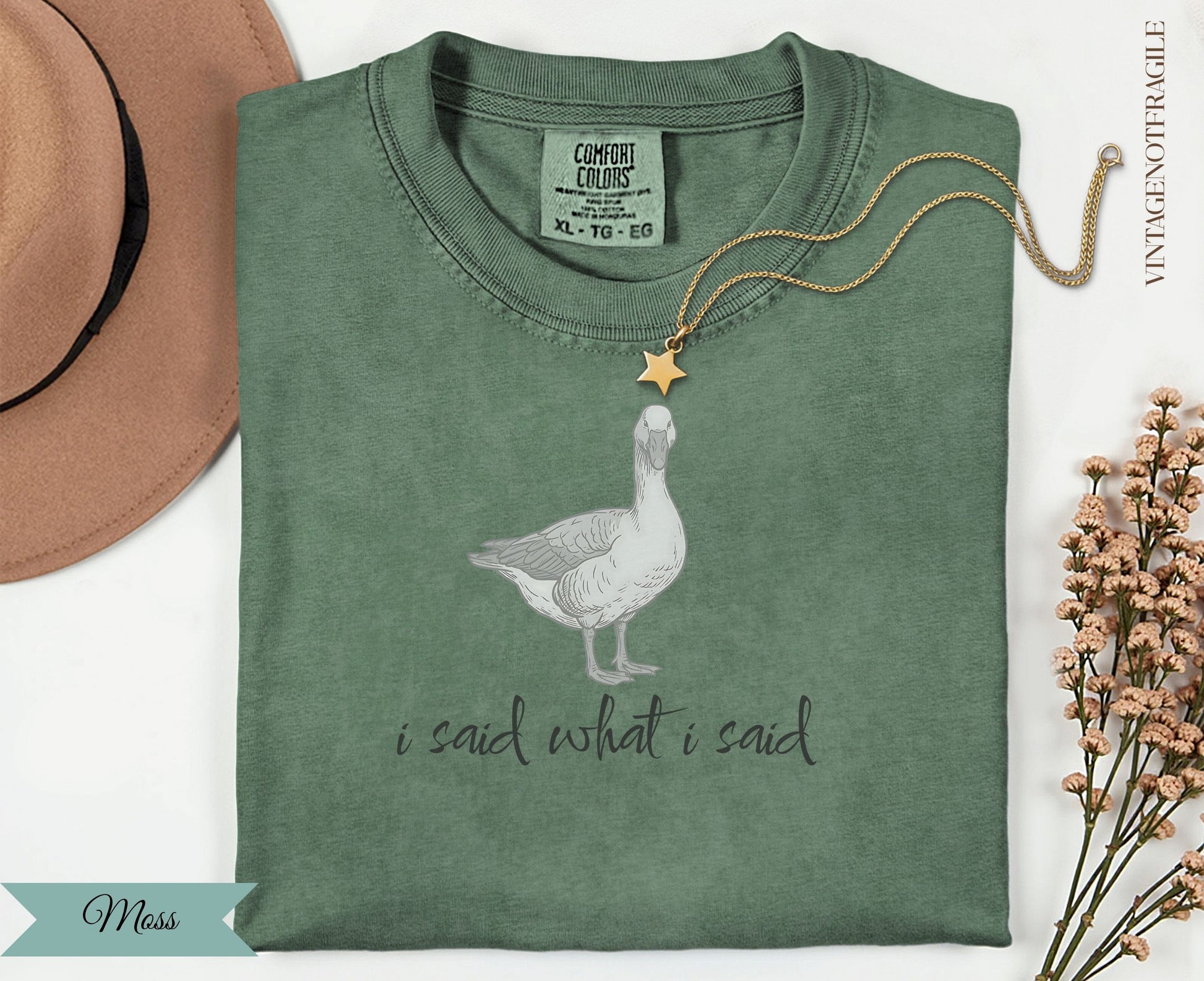 Green t-shirt with goose graphic and "i said what i said" text.