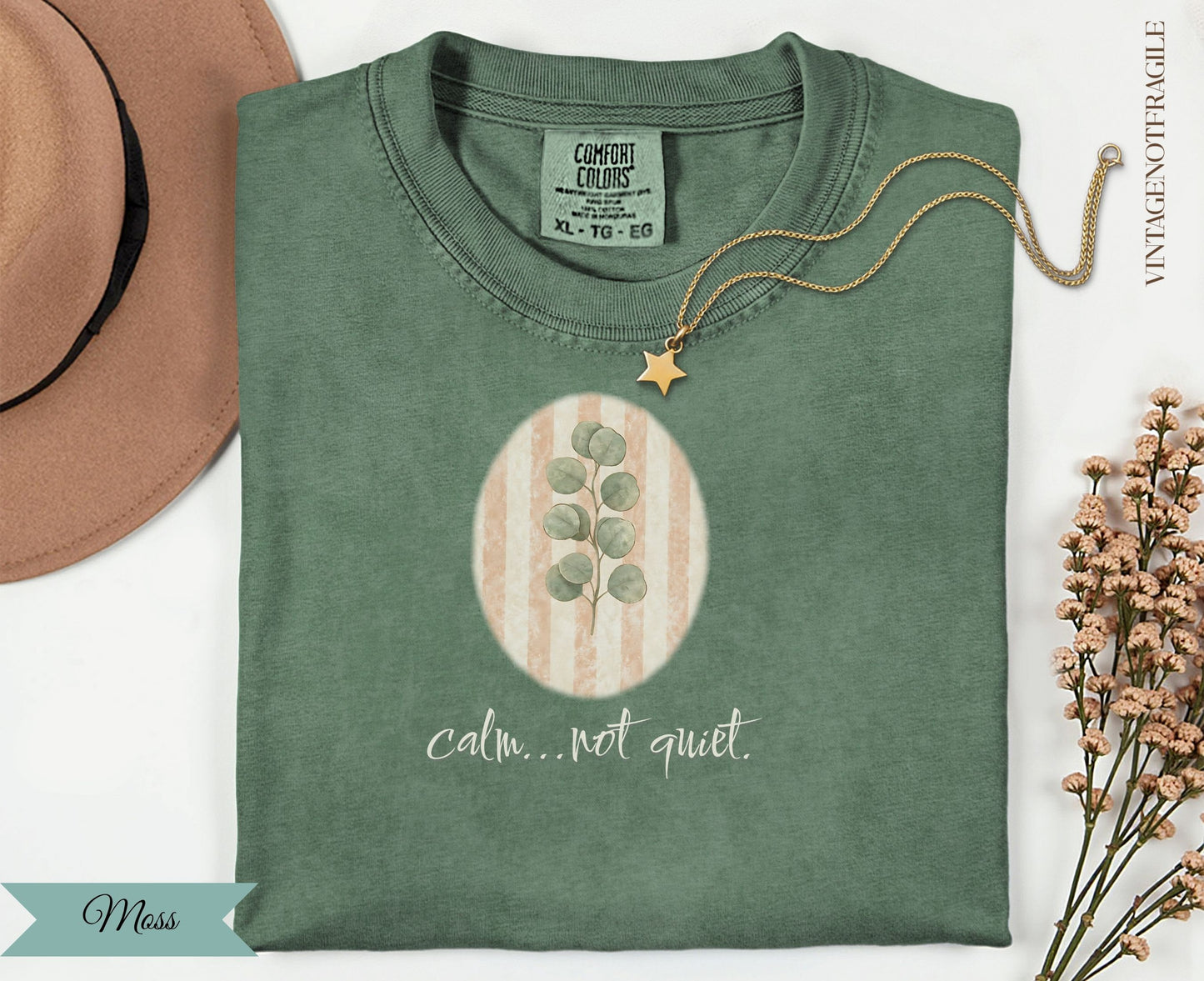 Green t-shirt with "calm...not quiet." text and eucalyptus illustration.