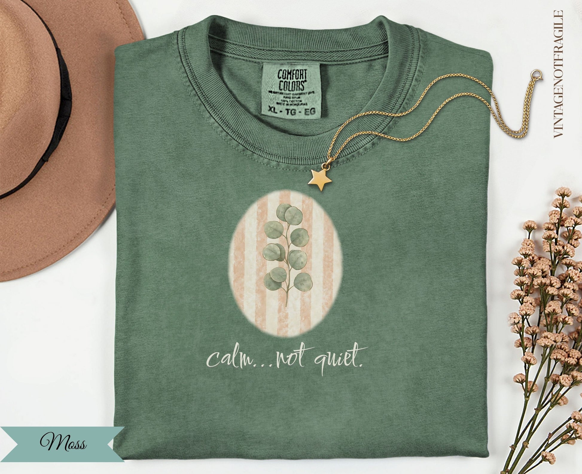 Green t-shirt with "calm...not quiet." text and eucalyptus illustration.
