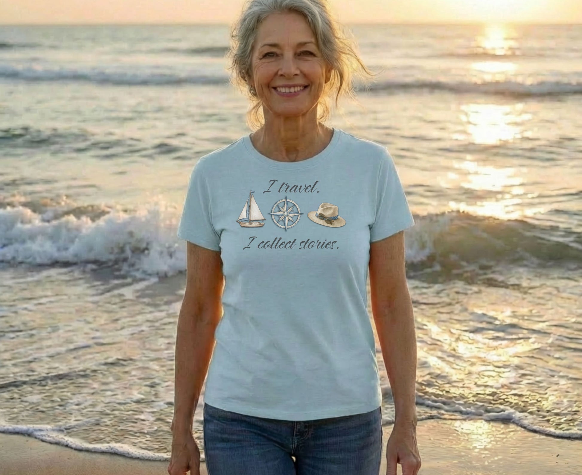Light blue t-shirt with sailboat and hat graphic, text "I travel. I collect stories."