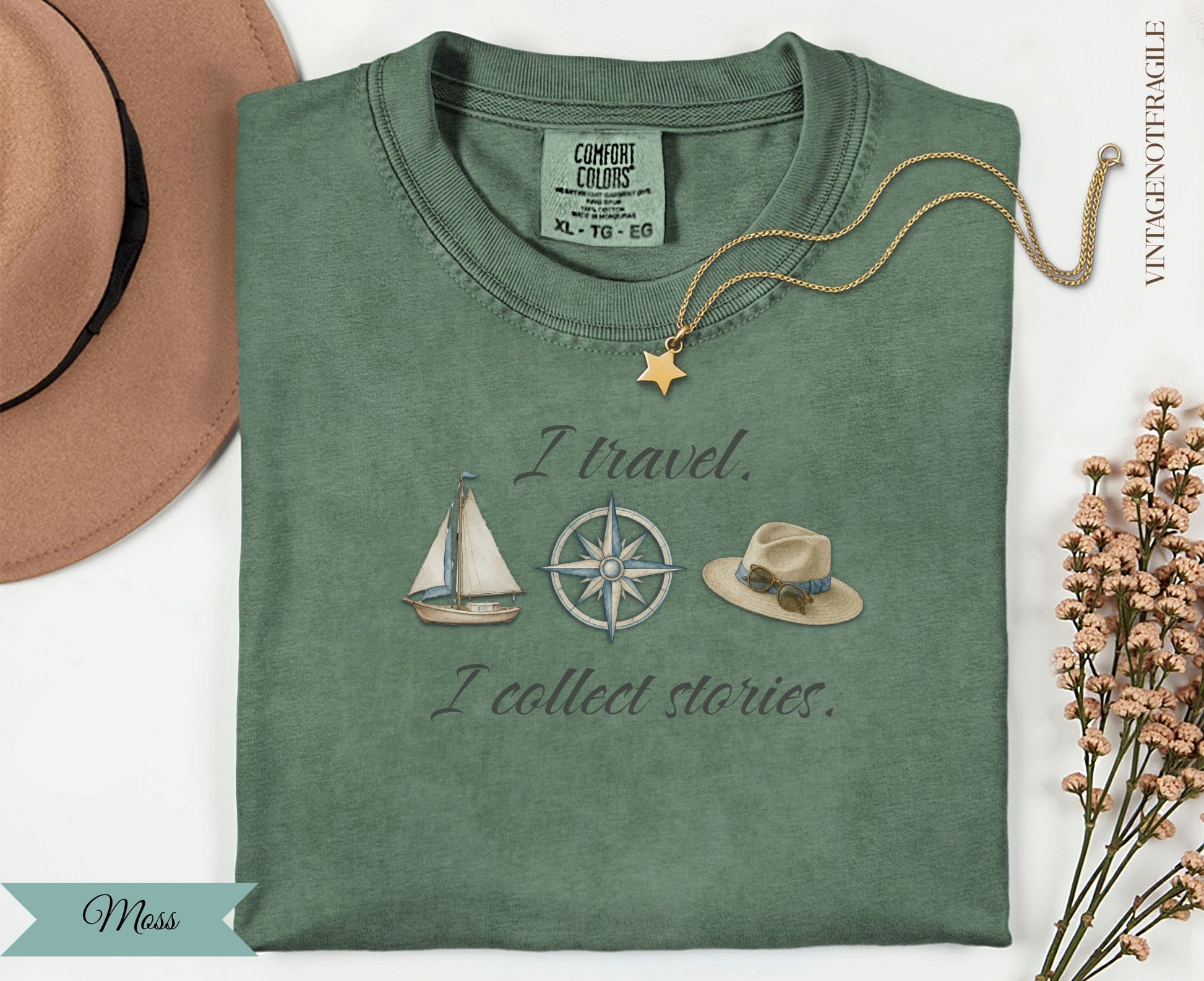 Moss green t-shirt with "I travel. I collect stories." and travel icons.