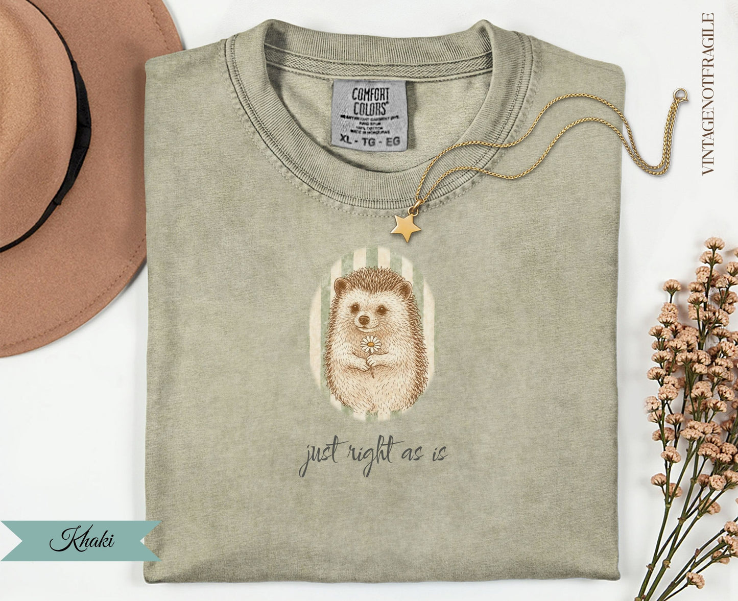 T-shirt with hedgehog holding a daisy, text "just right as is".
