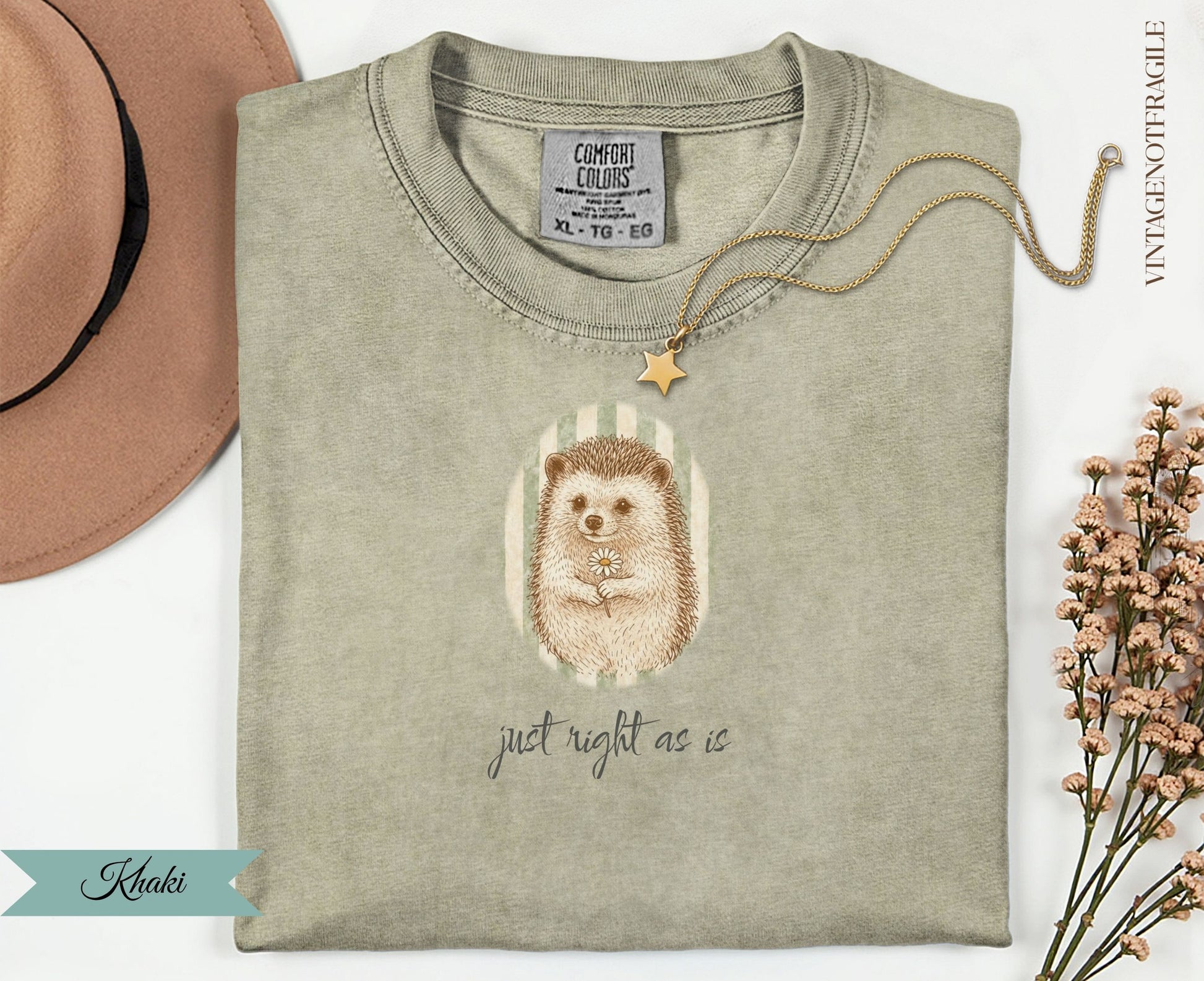 T-shirt with hedgehog holding a daisy, text "just right as is".