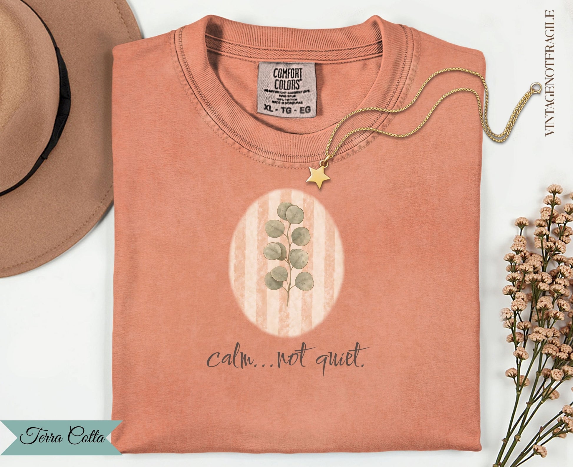 Terracotta t-shirt with eucalyptus branch and "calm...not quiet." text.