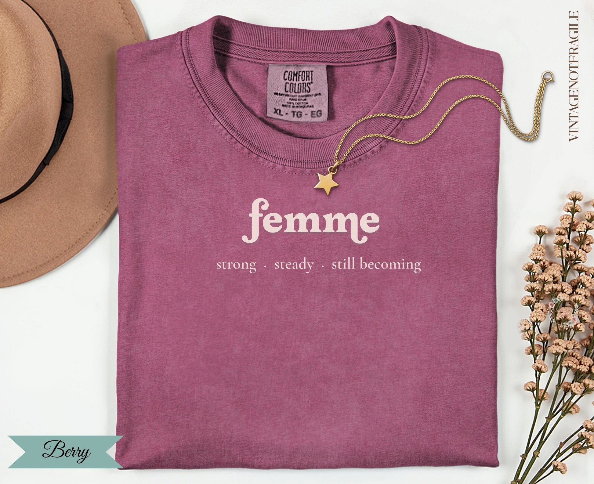 Berry t-shirt with "femme strong steady. still becoming" text.