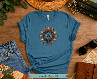 Teal t-shirt with colorful mandala design, jeans, sunglasses, and books.