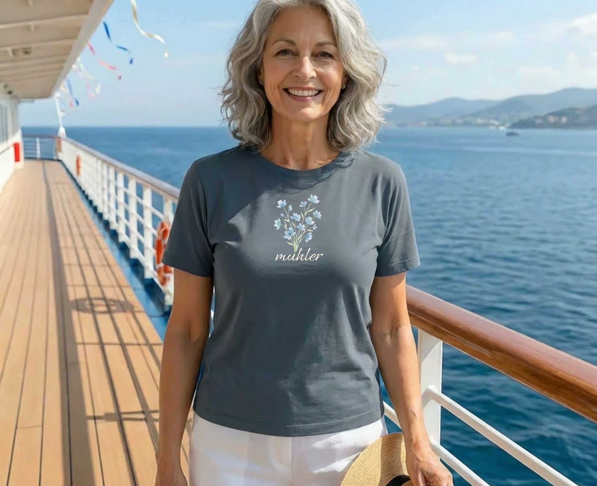 Woman wearing a grey t-shirt with a floral design and the word "Mahler".