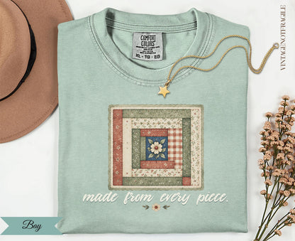 Light blue t-shirt with a quilt square design and text "made from every piece."