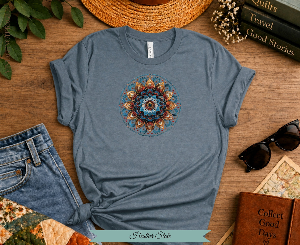 Blue heather slate t-shirt with colorful mandala graphic, jeans, and book.