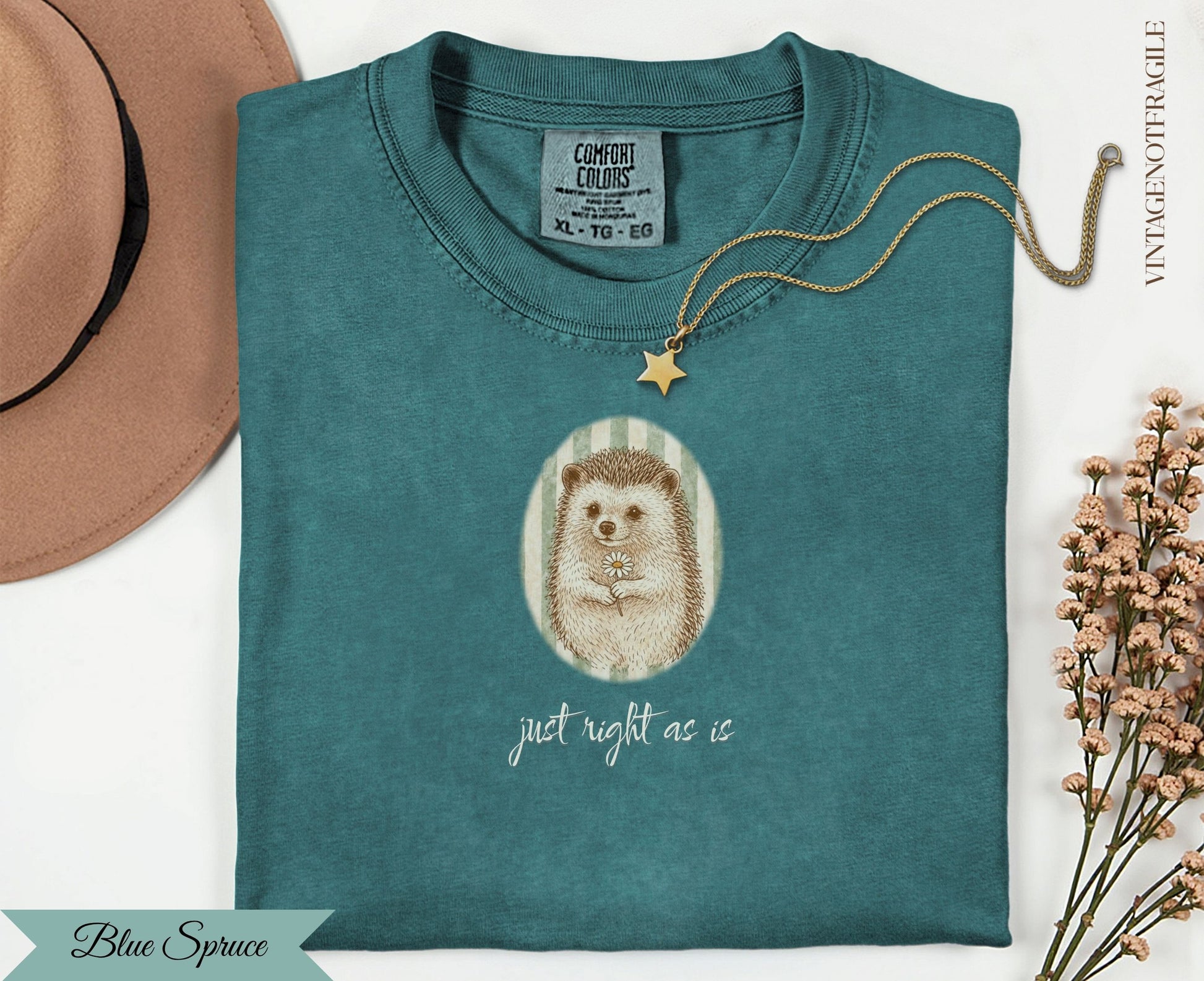 Teal t-shirt with hedgehog wearing a flower crown and text "just right as is".