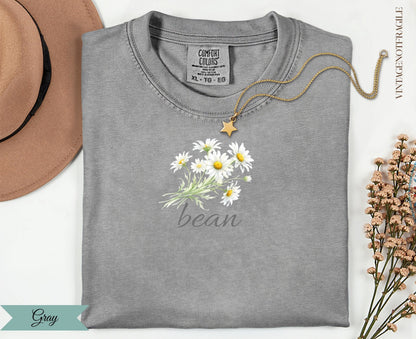 Gray t-shirt with a bouquet of white daisies and "bean" text.