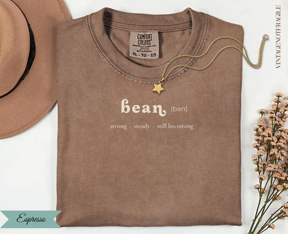 Comfort Colors espresso t-shirt with "bean (ban) strong steady. still becoming" text.