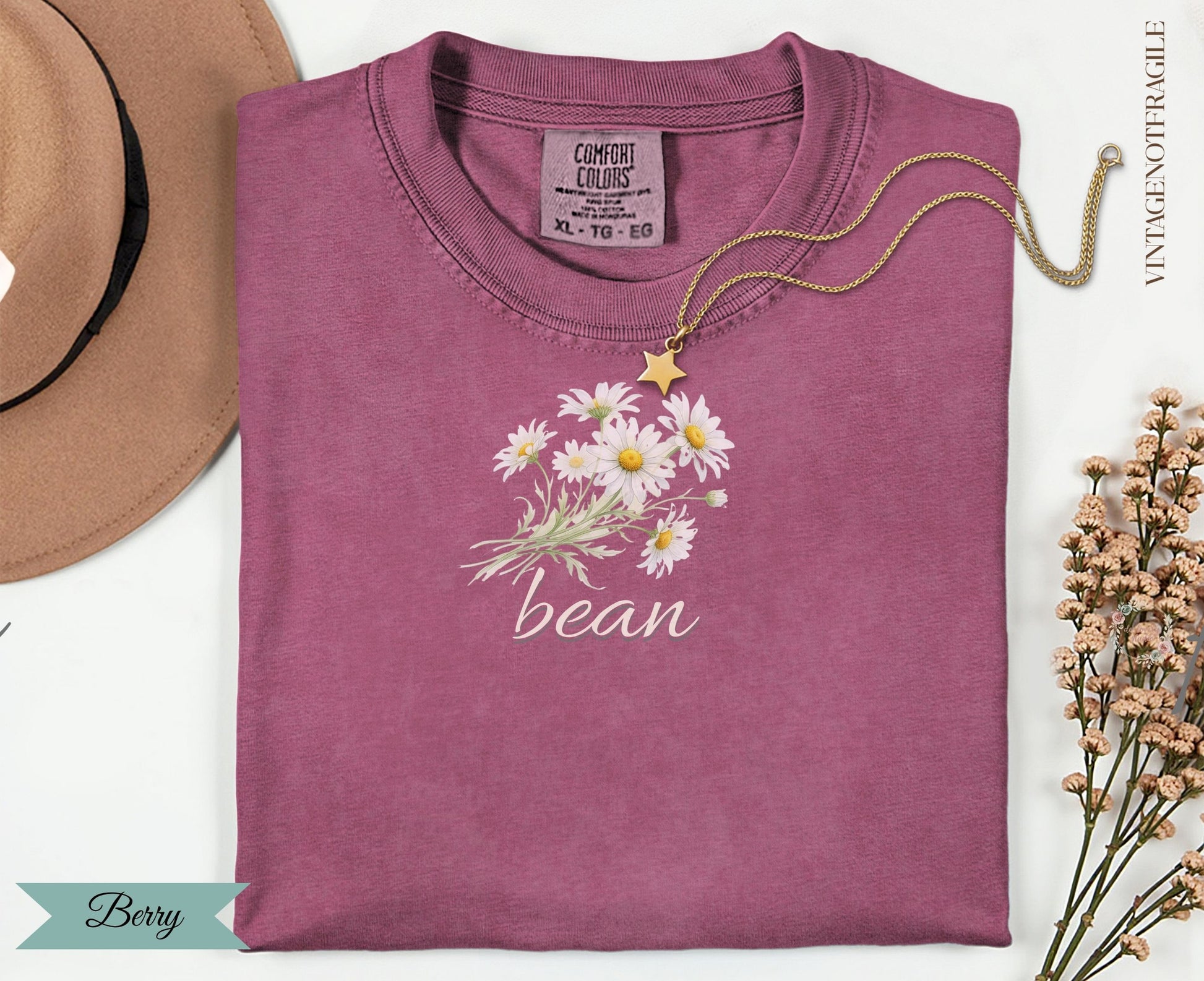 Berry colored t-shirt with "bean" and daisy graphic.