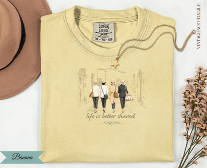 Cream t-shirt with graphic of four women walking with the text "Life is better shared".