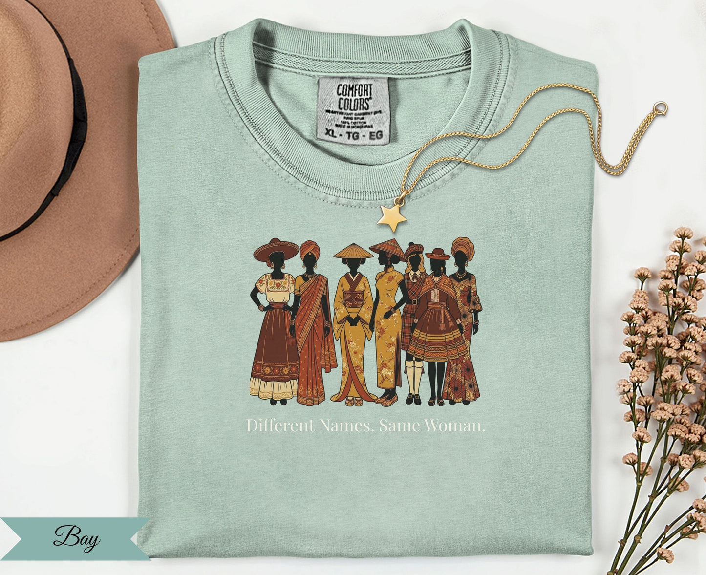 T-shirt with diverse women in traditional clothing and text "Different Names. Same Woman."