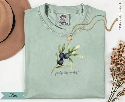 Mint green t-shirt with olive branch illustration and "perfectly content" text.