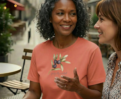 Woman in coral t-shirt with olive branch design.