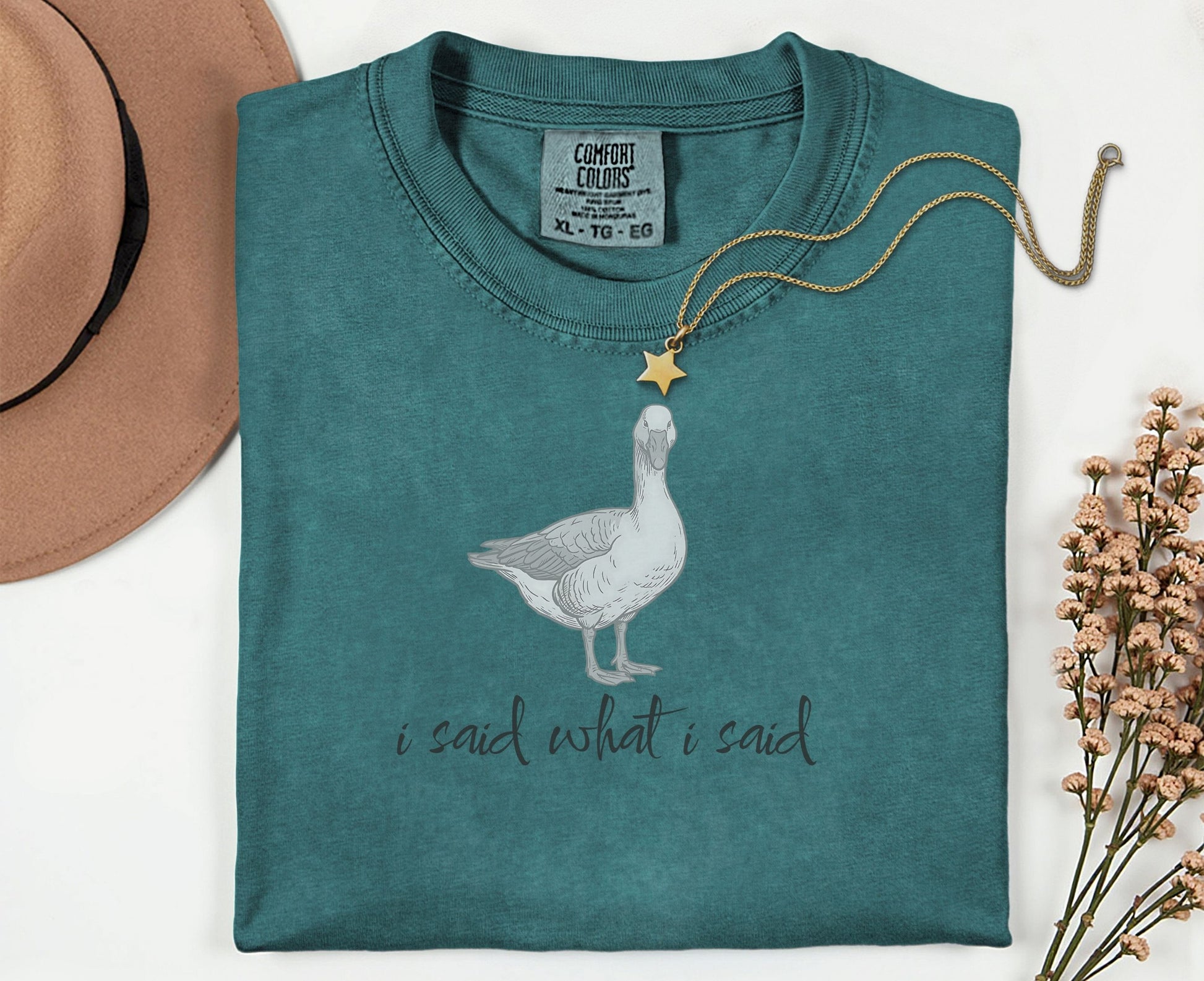 Teal t-shirt with a goose graphic and "I said what I said" text.