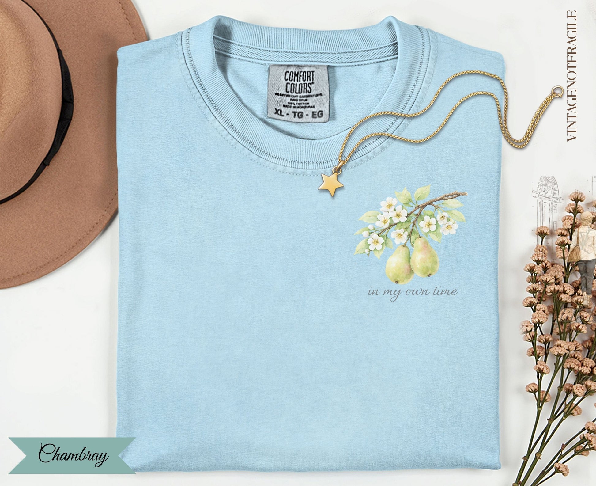 Light blue t-shirt with pear branch design and "in my own time" text.