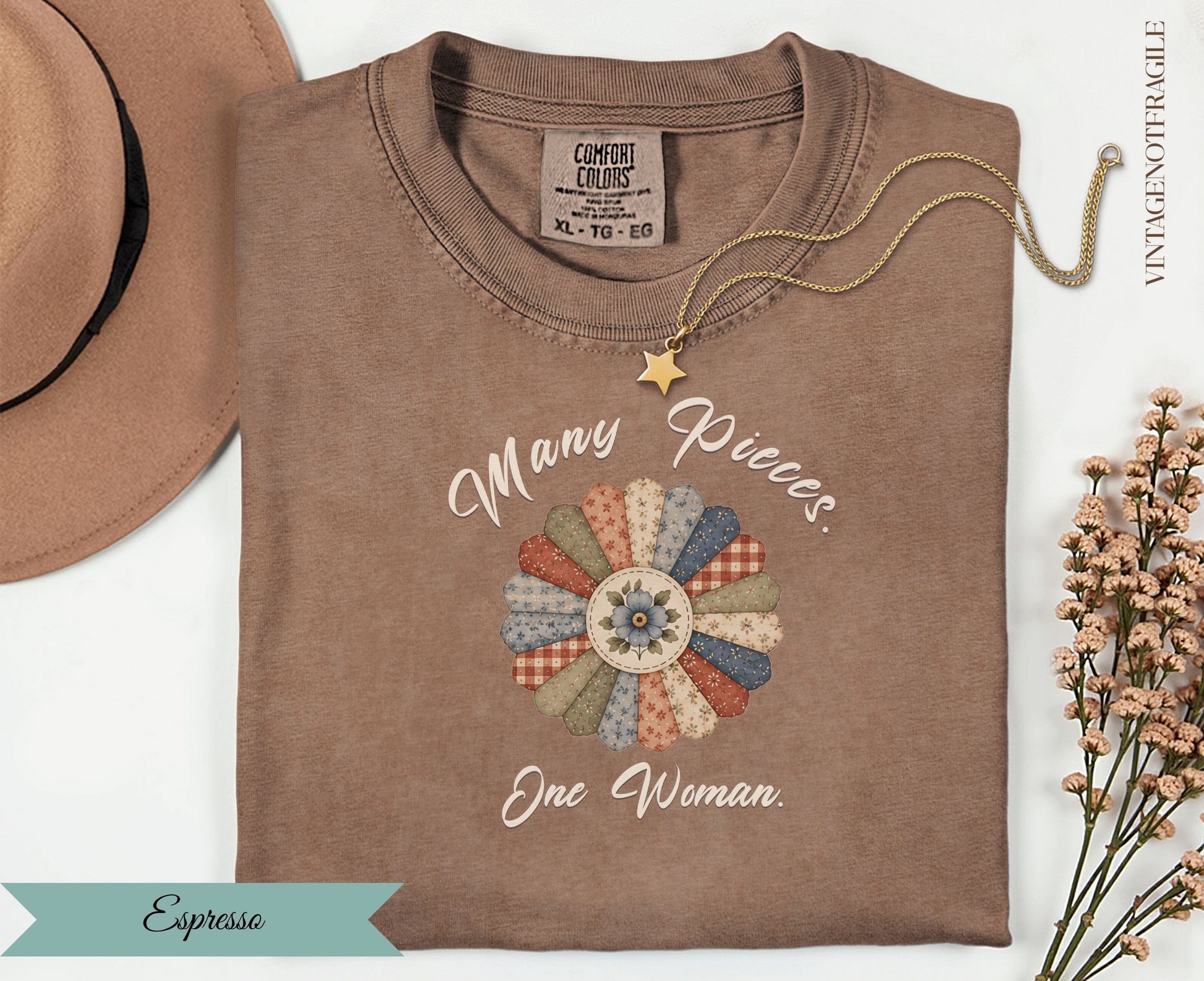 Brown t-shirt with floral graphic and text "Many Pieces One Woman".