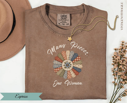 Brown t-shirt with floral graphic and text "Many Pieces One Woman".