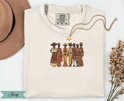 Cream t-shirt with a graphic of diverse women in traditional attire.