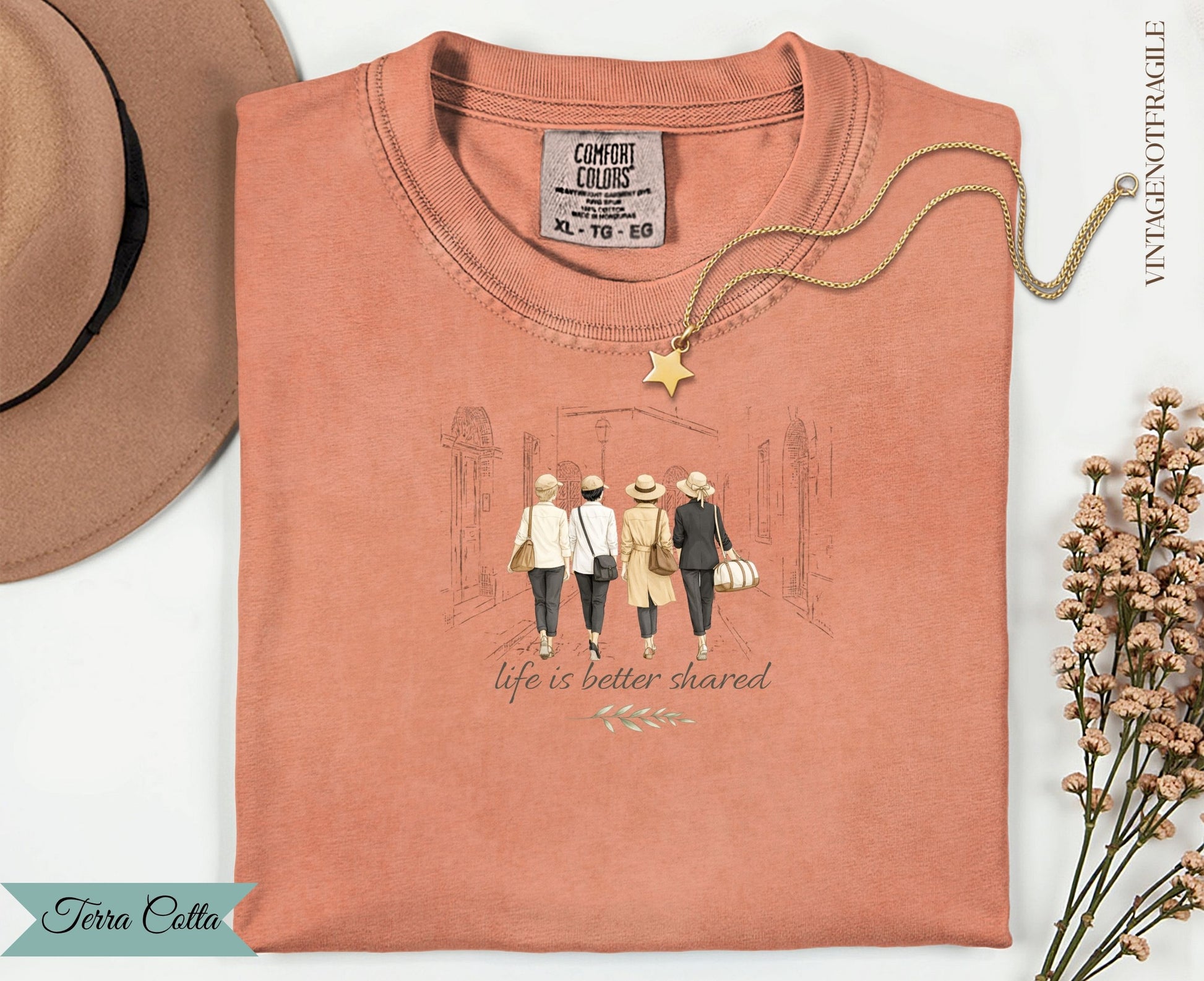 T-shirt with graphic of four women walking with text "life is better shared".