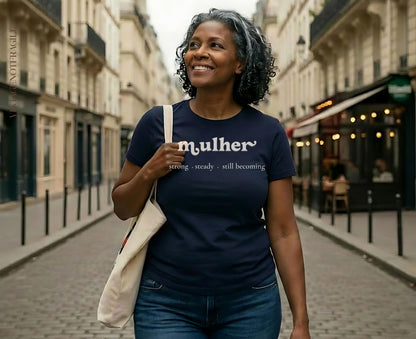Woman wearing navy t-shirt with "mulher" text, walking down a street.
