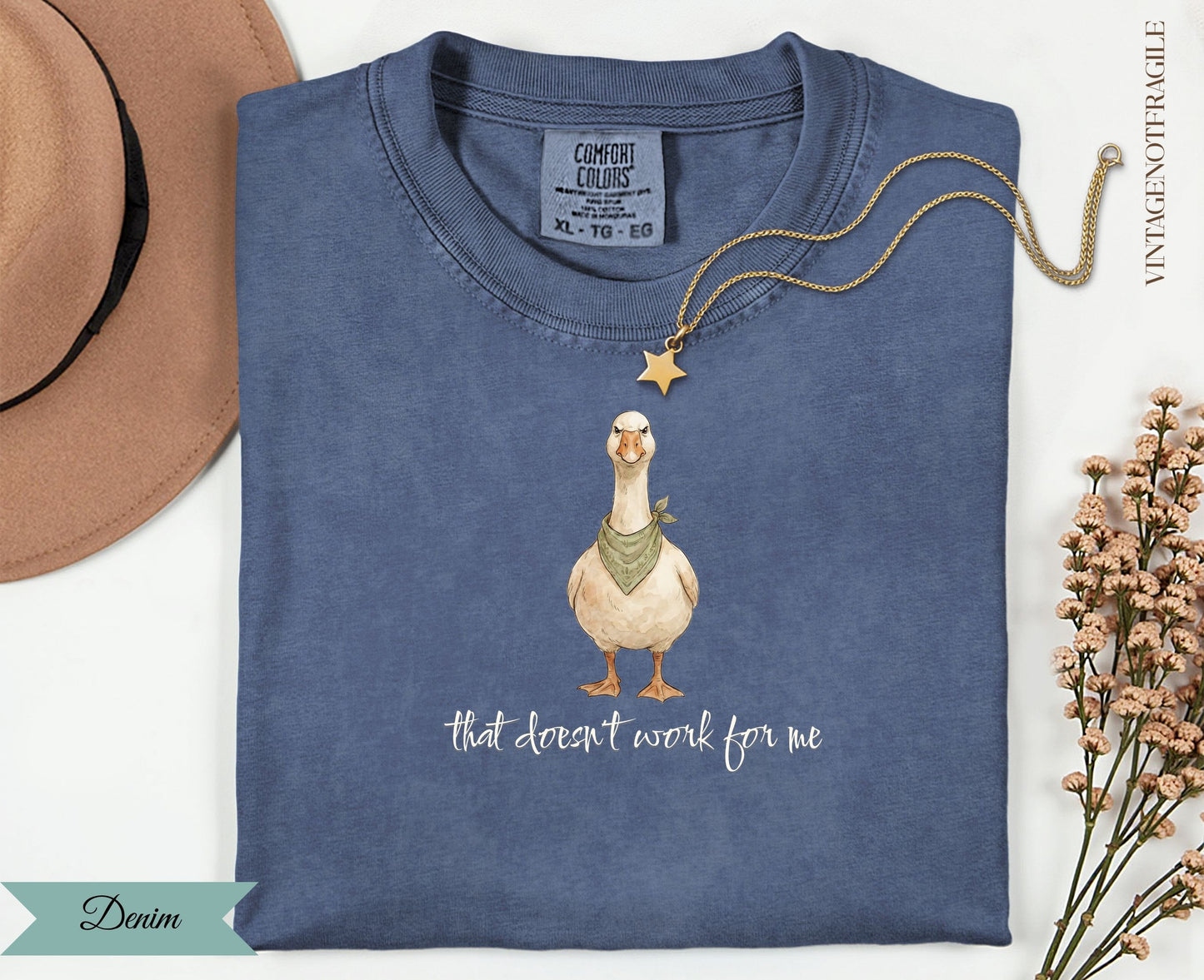 Blue t-shirt with a goose wearing a bandana and a star, text reads "that doesn't work for me".