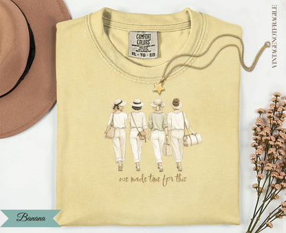 T-shirt with graphic of four women wearing hats and carrying bags; text "we made time for this".