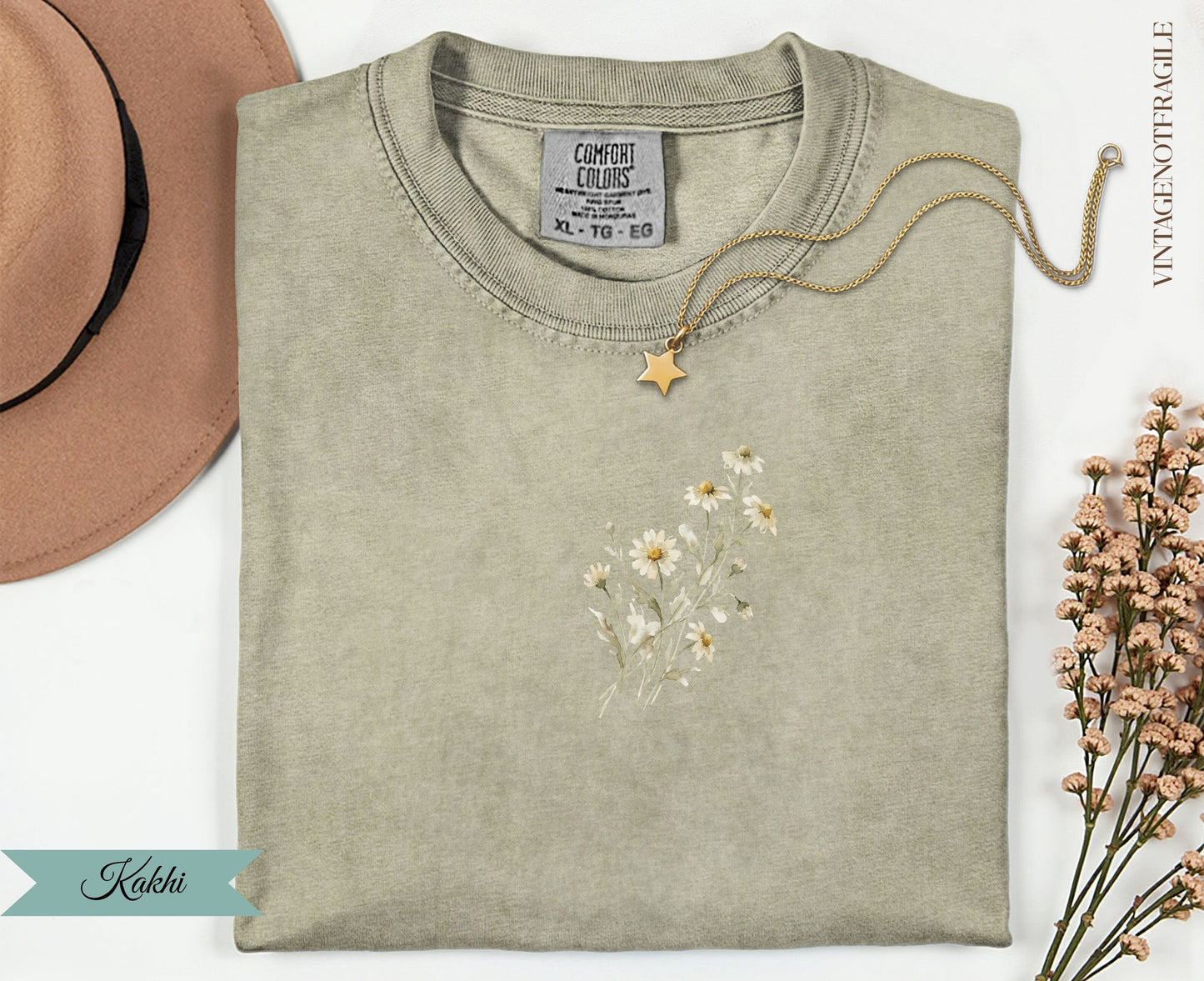 Light brown t-shirt with delicate daisy floral design and gold star necklace.