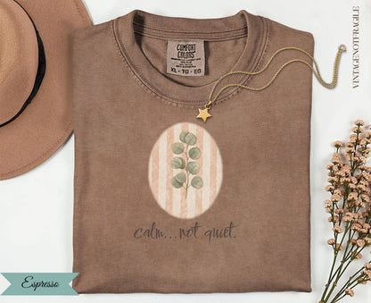Espresso Comfort Colors t-shirt with oval botanical design and text "calm...not quiet."