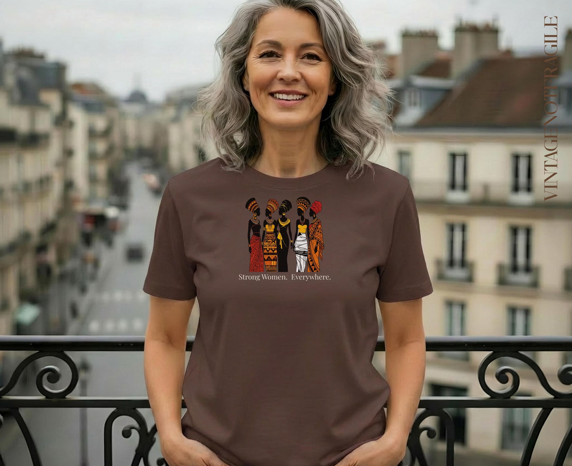 Woman wearing brown t-shirt with "Strong Women. Everywhere." graphic.