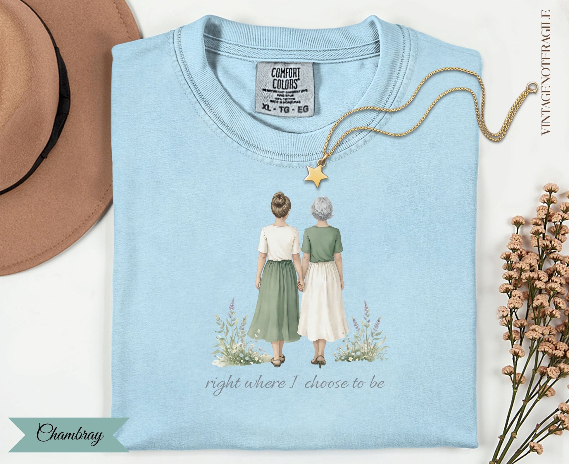 Light blue t-shirt with two women holding hands and the text "right where I choose to be."