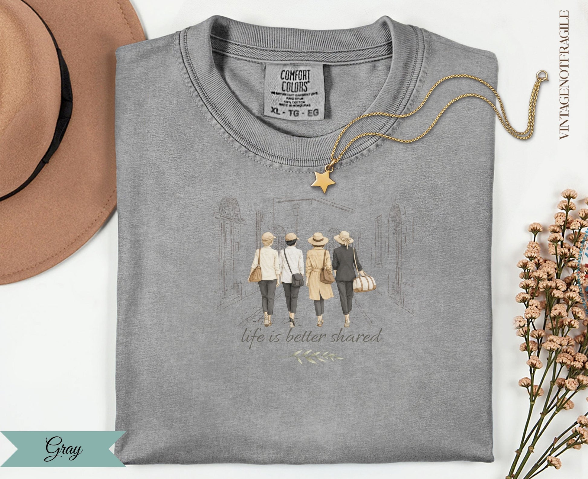 Gray t-shirt with illustration of four women walking, text "life is better shared".