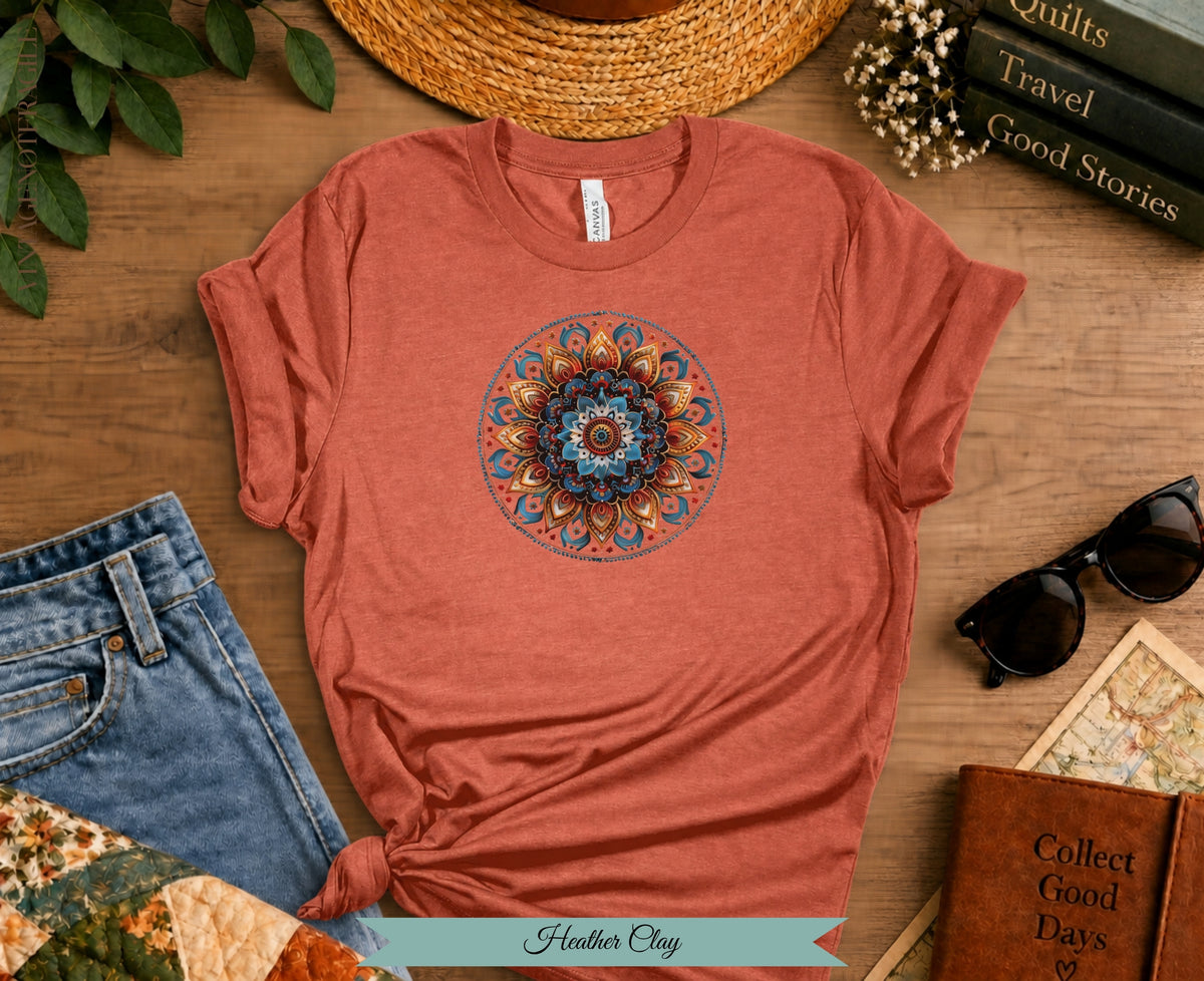Coral t-shirt with a blue and gold mandala design, styled with jeans and accessories.
