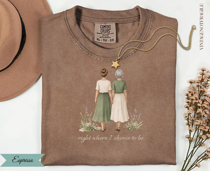 Brown Comfort Colors t-shirt with illustration of two women holding hands and text "right where I choose to be".