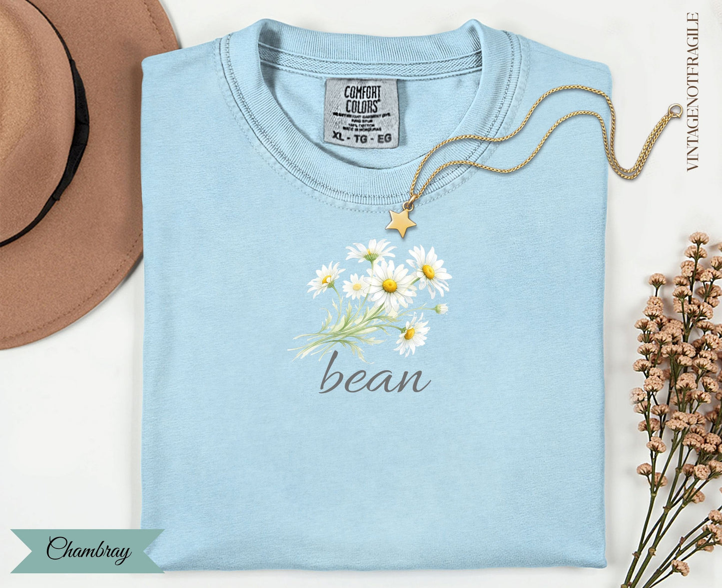 Light blue t-shirt with daisy bouquet and "bean" text.