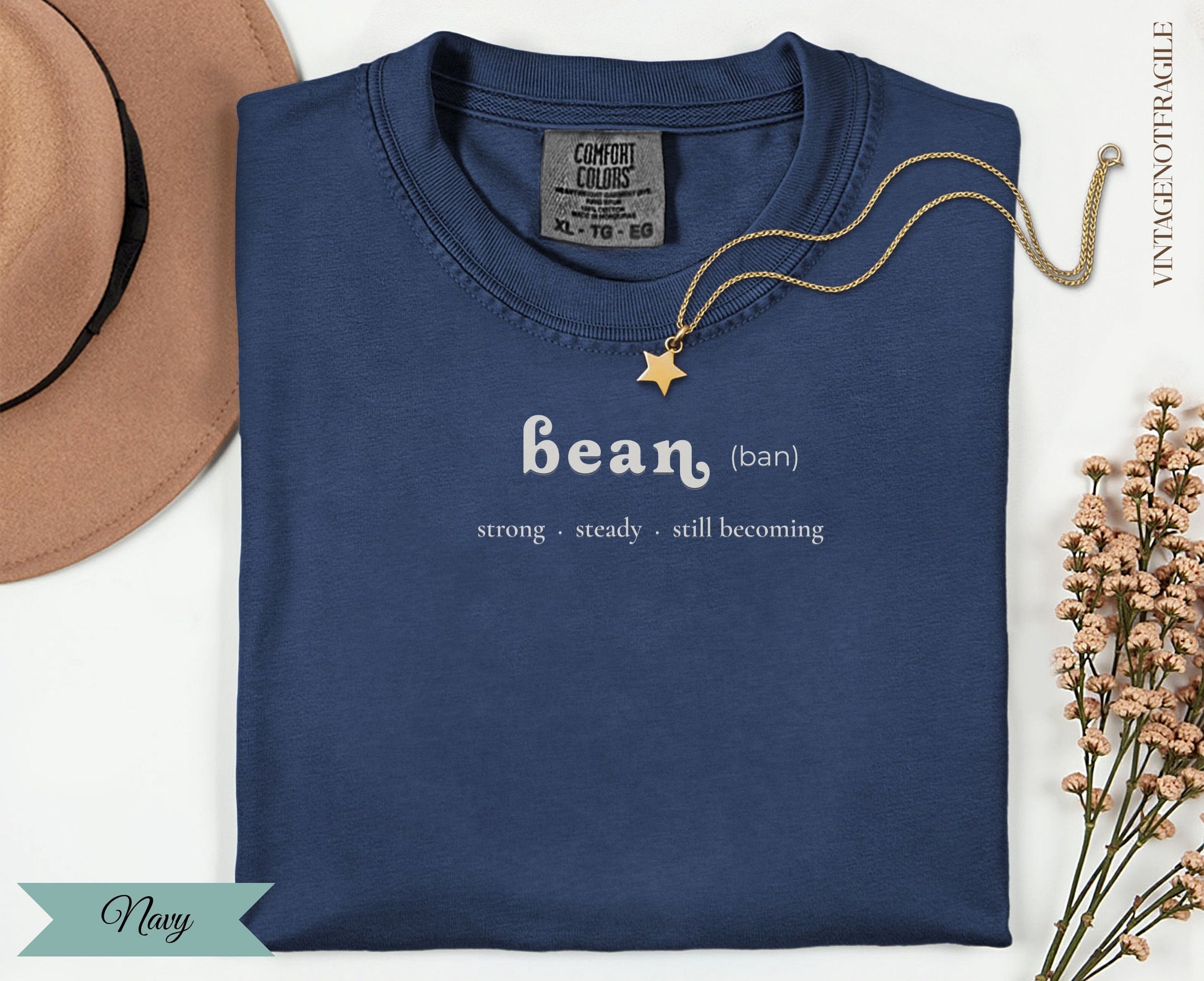 Navy t-shirt with "bean (ban)" text and inspirational phrases.