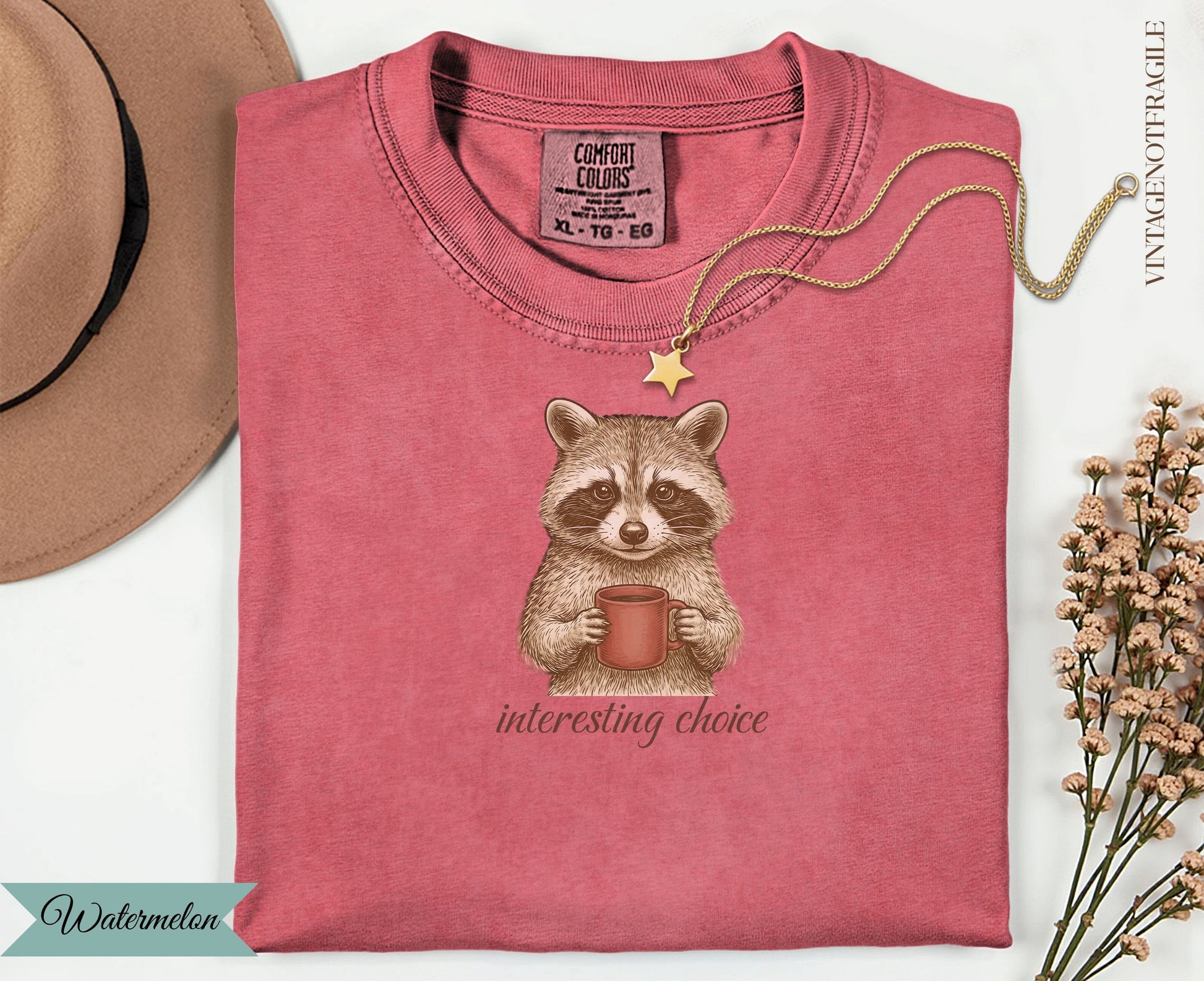 T-shirt with a raccoon holding a mug and the text "Interesting Choice".