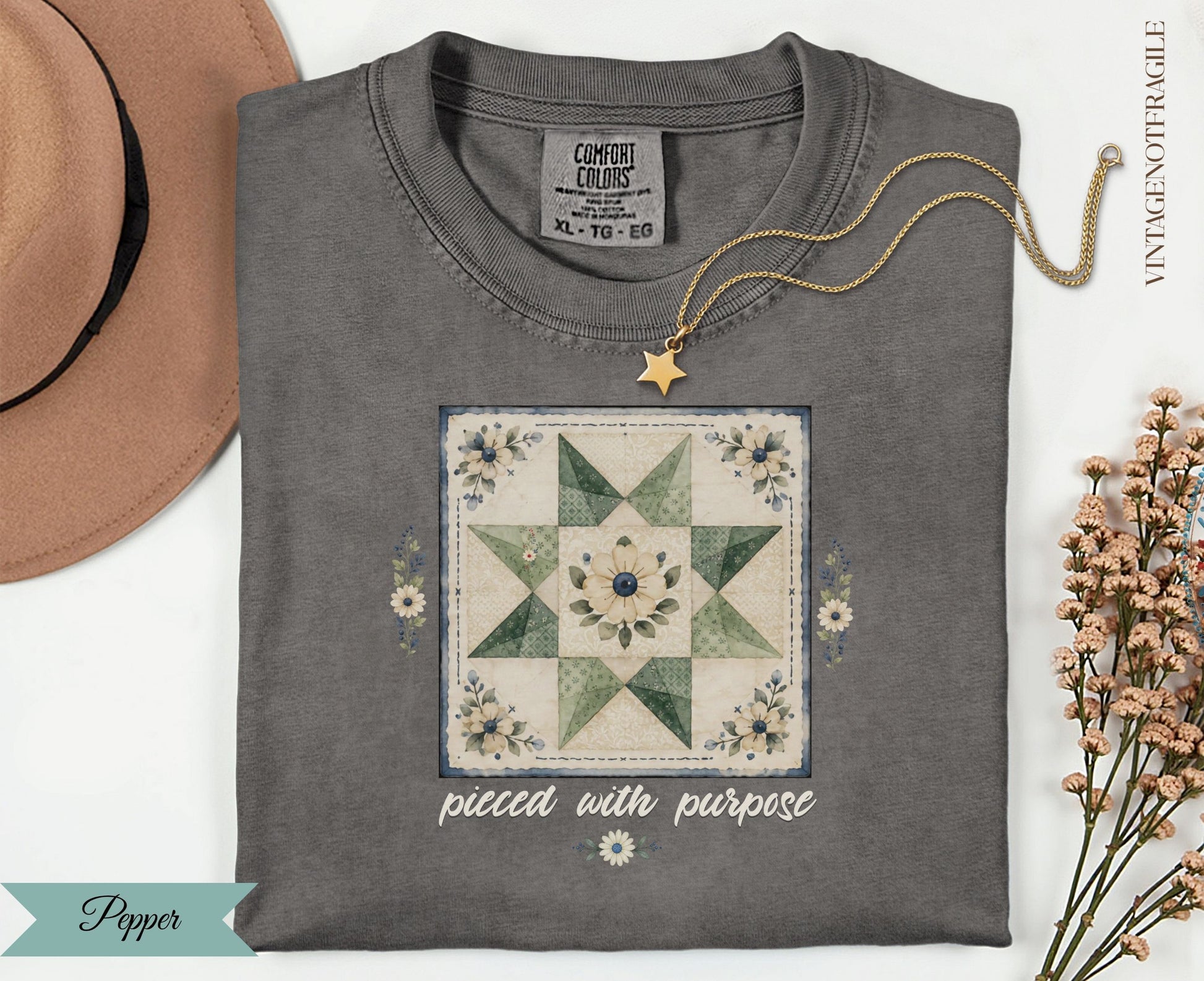 Charcoal t-shirt with a patchwork quilt design and "pieced with purpose" text.